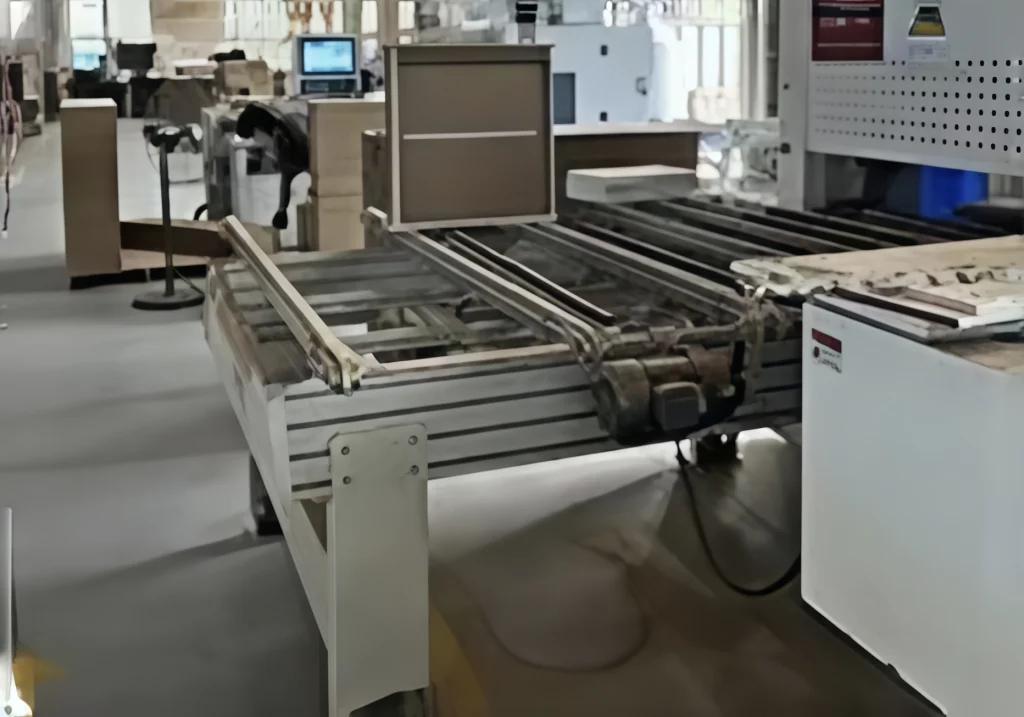 Industrial workspace with machinery for vinyl record storage cabinet production