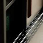 Close-up of vinyl record storage cabinet showcasing sleek design and textured surface.